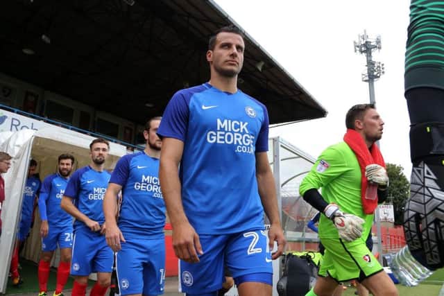 Steven Taylor walks out for his Posh debut in a friendly at Cheltenham.