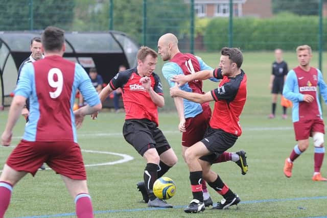 Ash Jackson (left, red) will be a key player for Netherton United this season.