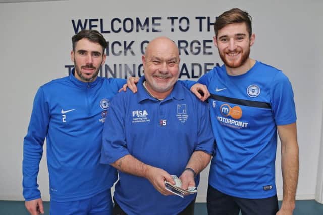 Posh players had a whip round and donated to the Chris Turner Statue Fund. Fund chairman Adi Mowles is flanked by Michael Smith (left) and Jack Baldwin (right).