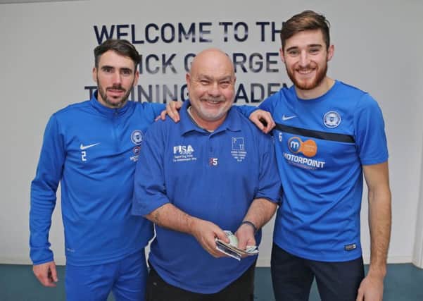 Posh players had a whip round and donated to the Chris Turner Statue Fund. Fund chairman Adi Mowles is flanked by Michael Smith (left) and Jack Baldwin (right).