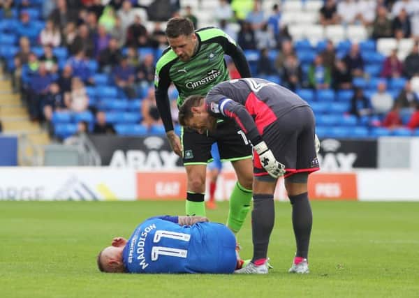 Marcus Maddison is down and he's not getting mush sympathy from Plymouth defender Sonny Bradley and goalkeeper Luke McCormick by the looks of it. Photo: Joe Dent/theposh.com.