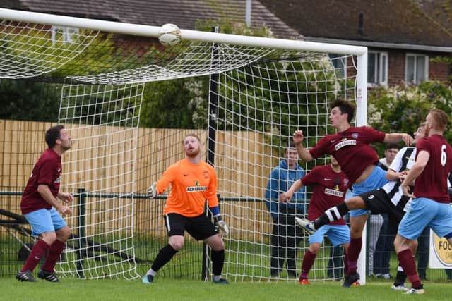 Zak Munton (stripes) partially hidden scores for Peterborough Northern Star against Deeping Rangers. Photo: Chantelle McDonald. @cmcdphotos..