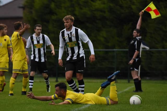Peterborough Northern Star's Jake Sansby commits a foul in the 5-0 defeat to Wellingborough Whitworth. Photo: Chantelle McDonald. @cmcdphotos.