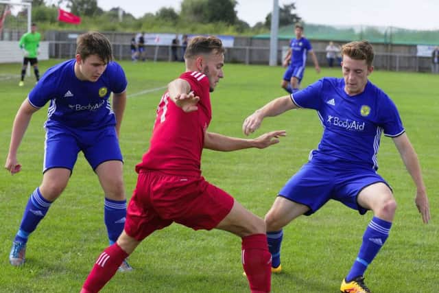 Dan Lawlor (blue) is an injury doubt for Peterborough Sports.