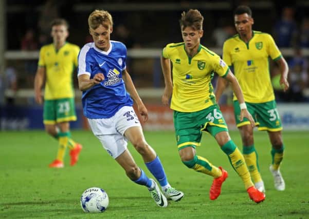 Peterborough United's Morgan Penfold in action with Norwich City's Todd Cantwell - Mandatory by-line: Peterborough United Football Club Ltd / PaperPix- 2016 - 16/17 - FOOTBALL - ABAX Stadium - Peterborough, Cambs - Peterborough United v Norwich City EMN-160831-144003002