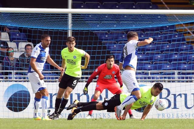 Posh defender Steve Taylor puts his body on the line to thwart Tom Nichols of Bristol Rovers. Photo: Joe Dent/theposh.com.
