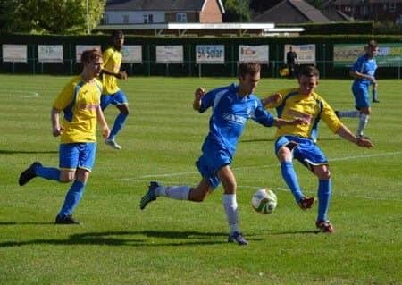 Zak Munton (blue) scored for Peterborough Northern Star at Harborough.
