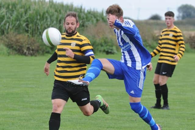 Action from AFC Stanground Sports v Moulton Harrox (blue). Photo: David Lowndes.
