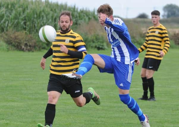 Action from AFC Stanground Sports v Moulton Harrox (blue). Photo: David Lowndes.