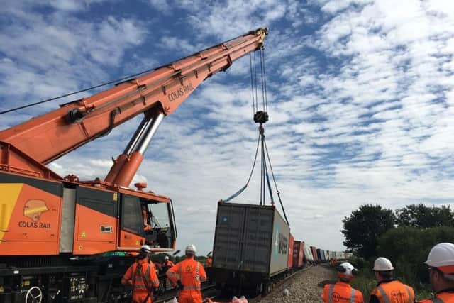 The crane lifts the derailed trains. Pic: Network Rail