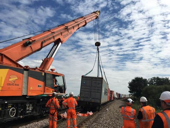 The crane lifts the derailed trains. Pic: Network Rail