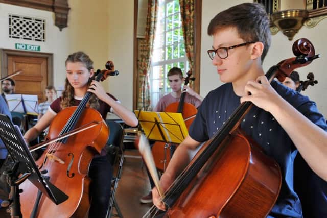 Members of the Peterborough Youth Orchestra rehearsing for a concert at the Town Hall.