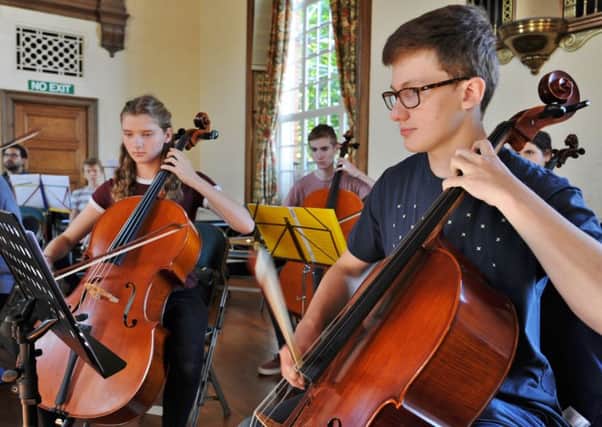 Members of the Peterborough Youth Orchestra rehearsing for a concert at the Town Hall.