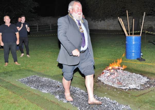 Mayor of Peterborough Coun. John Fox fire walking with a group raising money for the  Soul Happy charity at the Black Horse at Elton EMN-170709-090325009