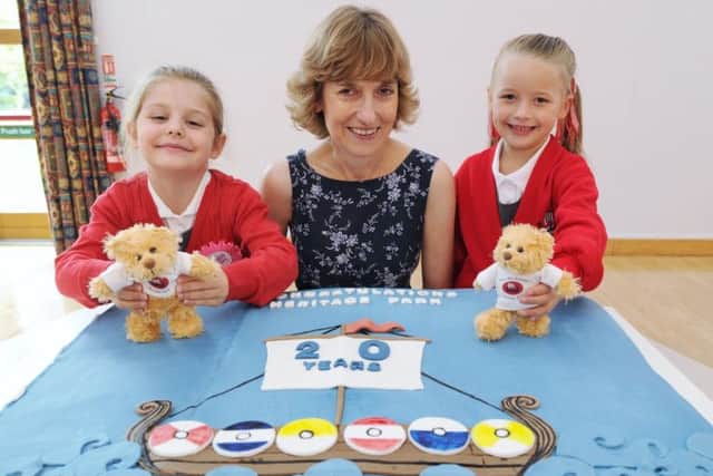 Hertiage Park primary school celebrates  its twenty years since opening. Two giants birthday cakes  for the pupils. Pictured are Isabella Parkinson,  and Freya Pinfold with head teacher Karen Hepworth-Lavery EMN-170809-144633009