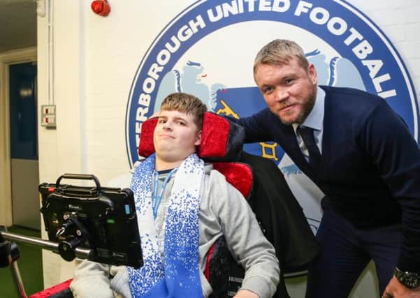 Peterborough United Manager Grant McCann with Ryley before the game