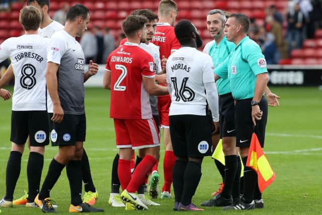 Posh striker Junior Morias congratulates the officials at full-time at Walsall. Photo: Joe Dent/theposh.com.