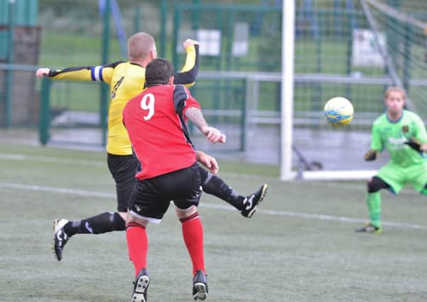 Action from Netherton B (red) v Ramsey Reserves at the Grange. Photo: David Lowndes.