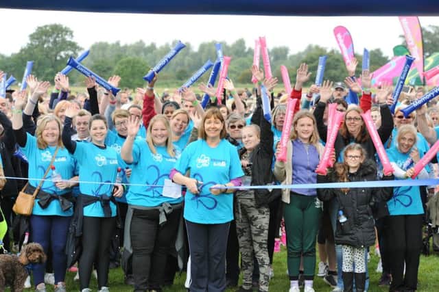 Alzheimers Memory Walk at Ferry Meadows . Gillian Beasley cuts the ribbon to start the walk. EMN-170917-150338009