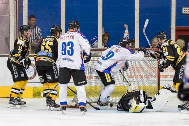 Will Weldon turns away in celebration after scrambling the puck home against Bracknell. Picture: Tom Scott