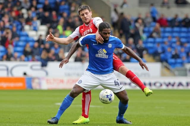 Posh midfielder Anthony Grant faces a fight to hold onto his starting place for the visit of Wigan.