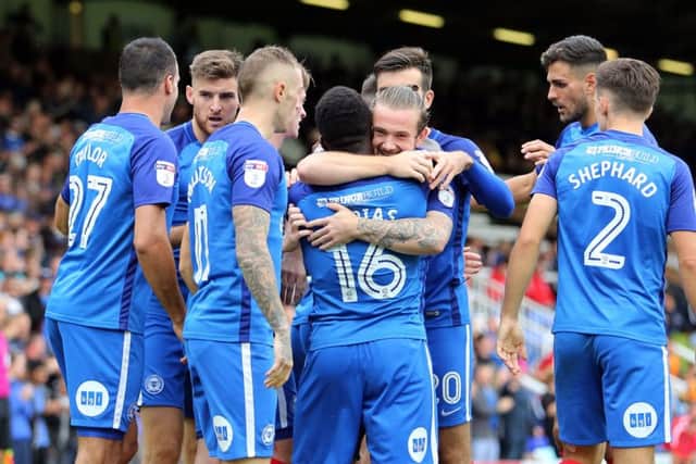 Posh goalscorers Jack Marriott and Junior Morias have a hug after the latter's first goal against Wigan. Photo: Joe Dent/theposh.com.
