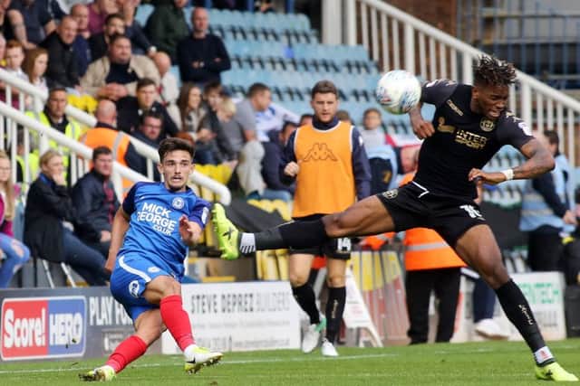 Liam Shephard makes a clearance for Posh against Wigan. Photo: Joe Dent/theposh.com.