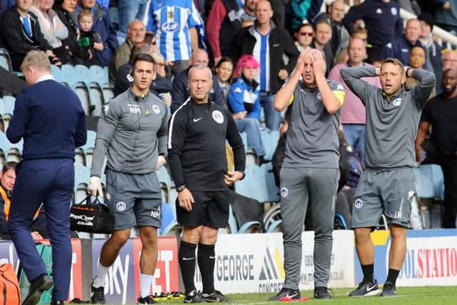Wigan manager Paul Cook can't believe what's he seeing at the ABAX Stadium. Photo: Joe Dent/theposh.com.