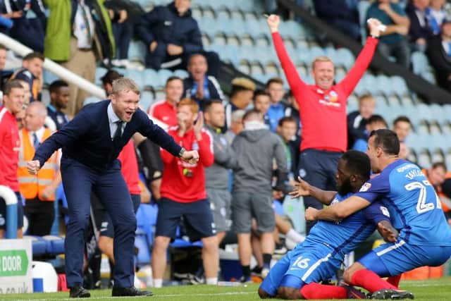 Posh manager Grant McCann wants to join in the celebrations with Junior Morias after his second goal against Wigan. Photo: Joe Dent/theposh.com.