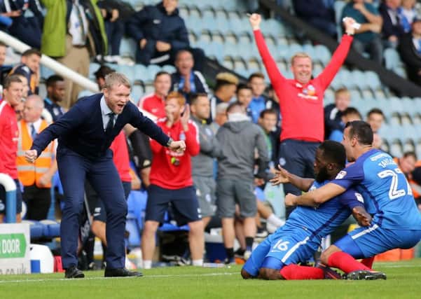 Posh manager Grant McCann wants to join in the celebrations with Junior Morias after his second goal against Wigan. Photo: Joe Dent/theposh.com.