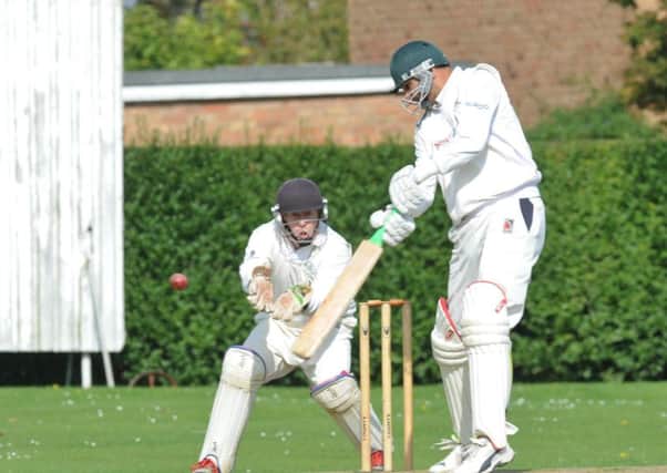 Ajaz Akhtar on his way to 58 for Barnack against Market Deeping. The wicket-keeper is Dave Sargeant. Photo: David Lowndes.
