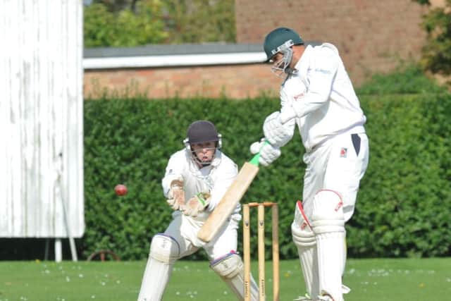 Ajaz Akhtar on his way to 58 for Barnack against Market Deeping. The wicket-keeper is Dave Sargeant. Photo: David Lowndes.