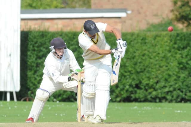 Barnack star Asim Butt was caught off this delivery from Deeping's Nick Green. Photo: David Lowndes.