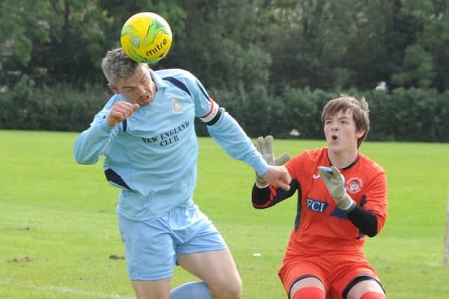 John Regan (left) in action for NECI during a 7-2 win over Holbeach United A at Werrington. Photo: David Lowndes.