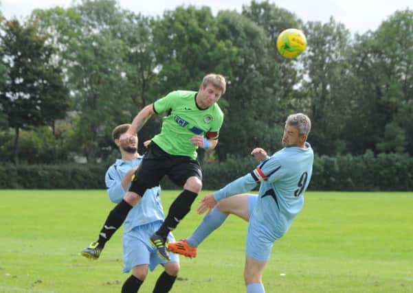 Action from Peterborough NECI against Holbeach United A (green) in Division Four of the Peterborough League. Photo: David Lowndes.