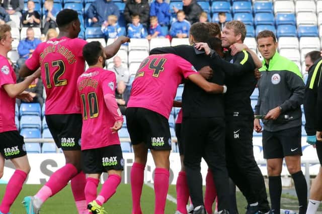 Posh manager Grant McCann and his players celebrate a 5-1 win at Oldham in 2015. Photo: Joe Dent/theposh.com.