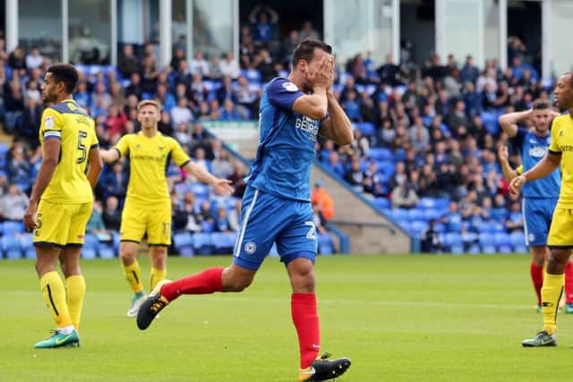 Posh centre-back Steven Taylor has just seen a header saved by Oxford 'keeper Simon Eastwood. Photo: Joe Dent/theposh.com.