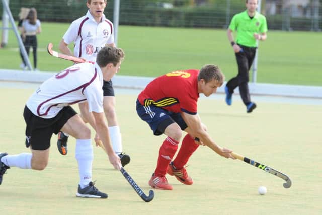 Ben Read (red) on the attack for City of Peterborough against Wapping. Photo: David Lowndes.