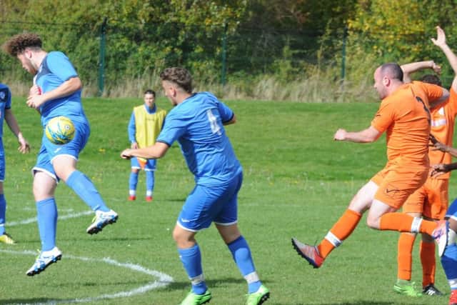 Action from AFC Orton's 7-2 win at Hampton (blue) in the PFA Minor Cup. Photo: David Lowndes.