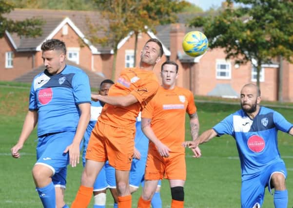 Action from Hampton (blue) v AFC Orton in the PFA Minor Cup. Photo: David Lowndes.