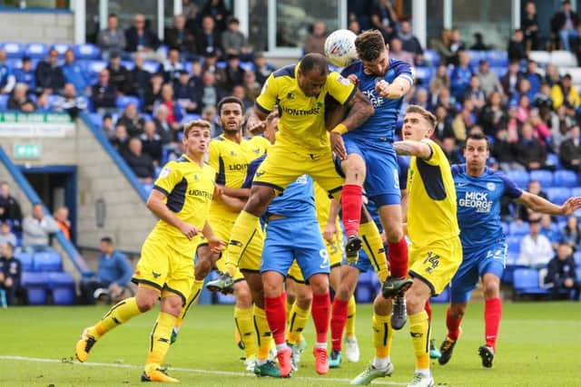 Posh captain Jack Baldwin challenges Oxford's Wes Thomas. Photo: Joe Dent/theposh.com.
