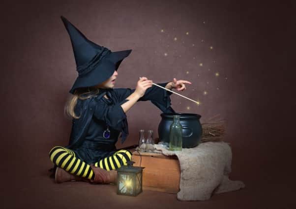 This little cute witch is making some magic potion