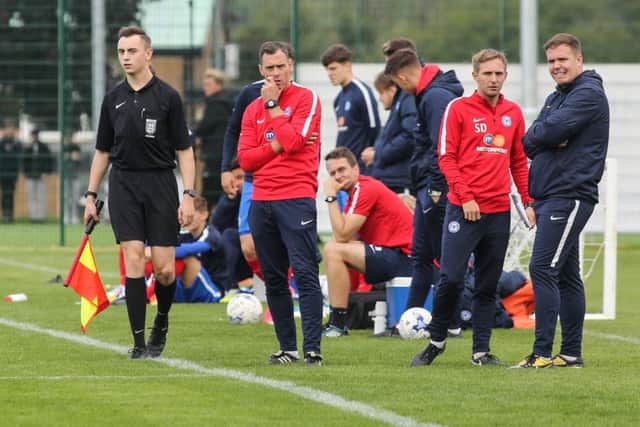 Posh Under 18 manager David Farrell (second left) and his assistant Sam Darlow (third left) watch their side in action. Photo: Joe Dent/theposh.com.