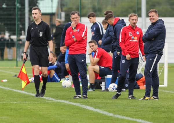 Posh Under 18 manager David Farrell (second left) and his assistant Sam Darlow (third left) watch their side in action. Photo: Joe Dent/theposh.com.