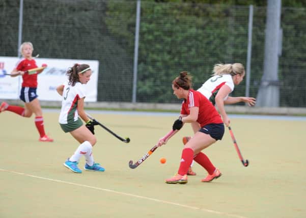 Action from City of Peterborough Ladies' (red) win over Norwich Dragons last weekend. Photo: David Lowndes.