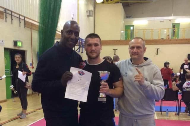 Michael Bulpin with ISKA UK director Clifton Findley and coach Rob Bulpin.