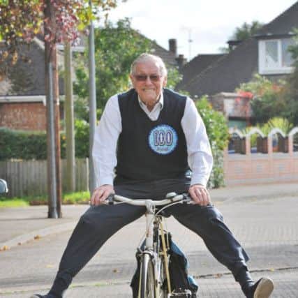 100-year-old Henry Jeffery at a street party to mark his birthday.  Arriving on his bike EMN-171014-175807009