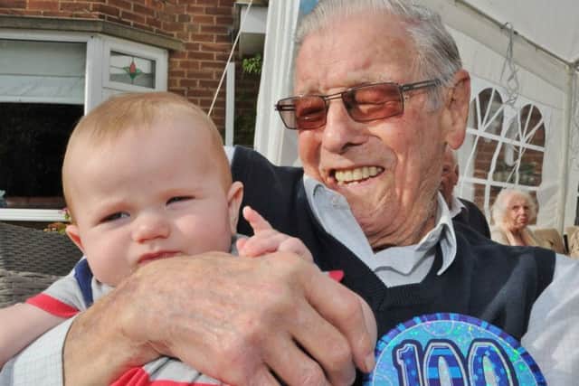 100-year-old Henry Jeffery at a street party to mark his birthday.  Henry with his youngest neighbour Harry Burton-Cook (1) EMN-171014-175843009