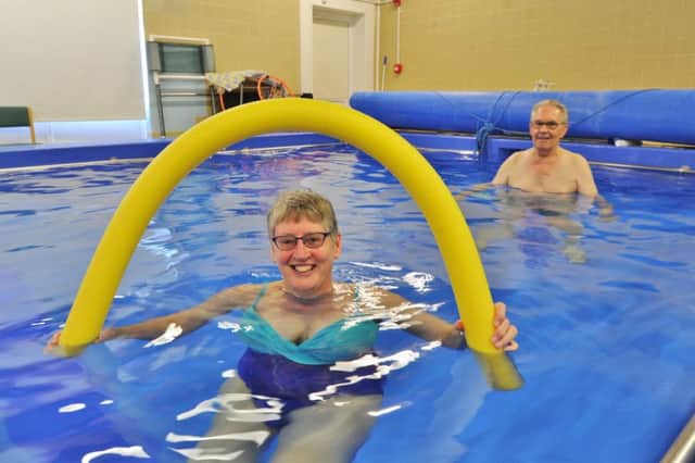 Sue Moore and Walter McCombe using the re-furbished hydrotherapy pool at Dogsthorpe. EMN-171017-153627009