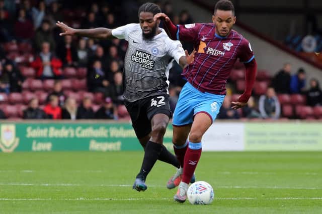 Anthony Grant of Posh battles for possession with Scunthorpe's Funso Ojo. Photo: Joe Dent/theposh.com.
